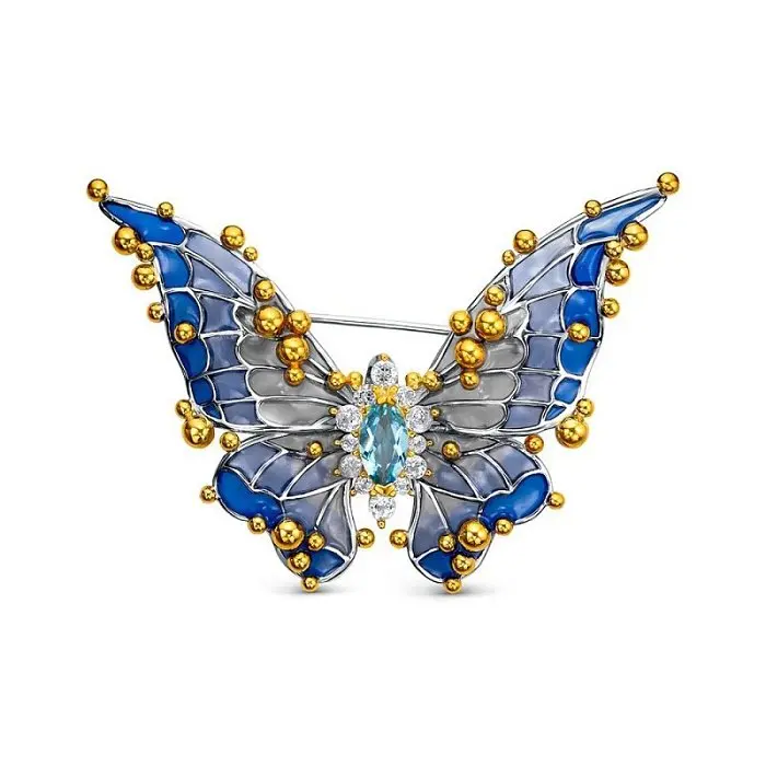 Брошь из позолоты с голубыми топазами